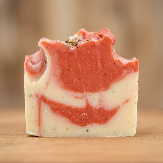 Close-up of Boat Deck handcrafted soap with coral and ivory swirls and an irregular top