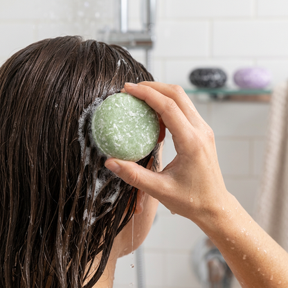Shampoo bar being used on wet hair